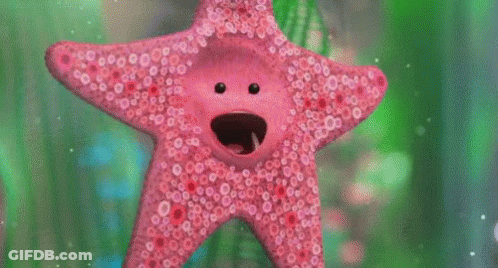 A Pink Starfish With A Face On It Is Swimming In A Tank . GIF
