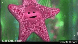 A Pink Starfish With A Face On It Is Swimming In The Water . GIF