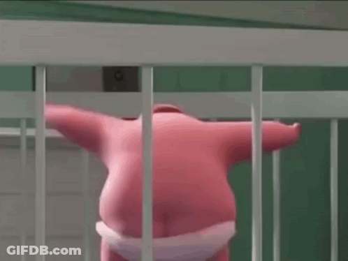 A Pink Stuffed Animal Is Standing In A White Cage Behind Bars . GIF