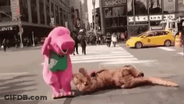 A Pink Stuffed Animal Is Standing Next To A Brown Stuffed Animal On A Street . GIF