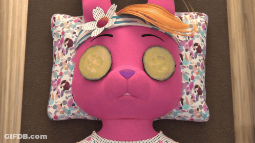 A Pink Stuffed Animal With Cucumber Slices On Her Eyes GIF