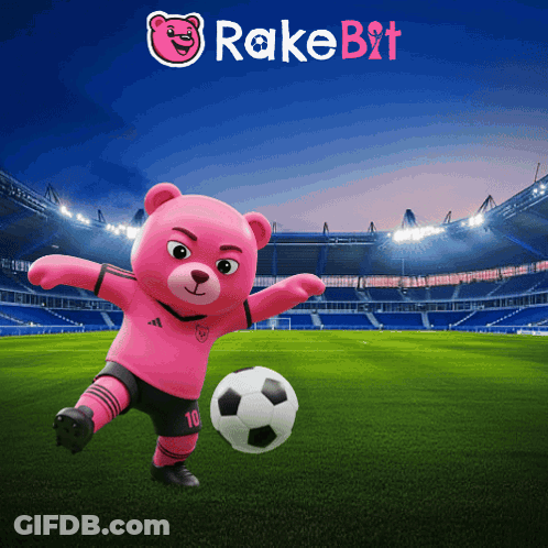 A Pink Teddy Bear Is Kicking A Soccer Ball In A Stadium With Rake Bit Written On The Bottom GIF