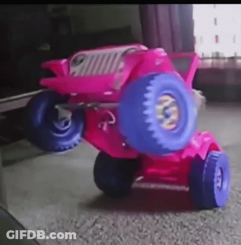 A Pink Toy Jeep With Blue Wheels And Tires GIF