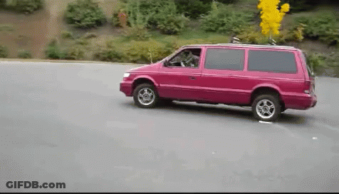 A Pink Van Is Driving Down A Road GIF