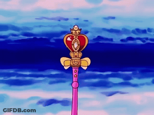 A Pink Wand With A Heart Shaped Top And A Crown On Top GIF