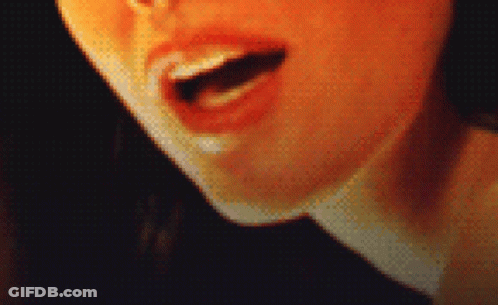 A Pixelated Close Up Of A Woman 'S Mouth With Her Tongue Out GIF