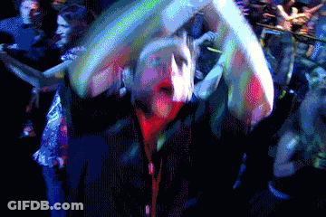 A Pixelated Image Of A Crowd Of People Dancing In A Dark Room GIF
