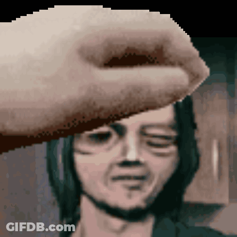 A Pixelated Image Of A Hand Touching A Man 'S Forehead With His Eyes Closed GIF