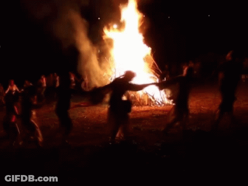 A Pixelated Image Of A Man Dancing In Front Of A Fire GIF