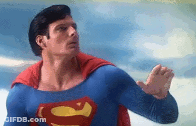 A Pixelated Image Of A Man In A Superman Costume Flying In The Sky . GIF