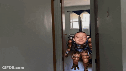 A Pixelated Image Of A Man 'S Face In A Hallway GIF