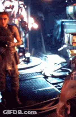 A Pixelated Image Of A Man Standing In A Room With The Letter F On His Arm GIF
