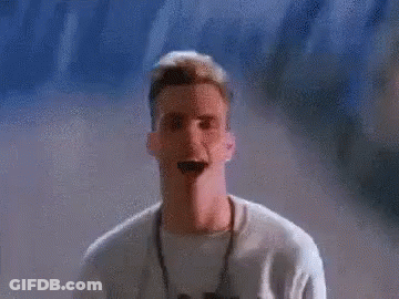 A Pixelated Image Of A Man Standing In Front Of A Wall With The Letter C In The Background GIF