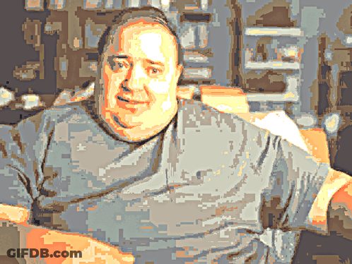 A Pixelated Image Of A Man Wearing A Grey Shirt With A White Star On It GIF