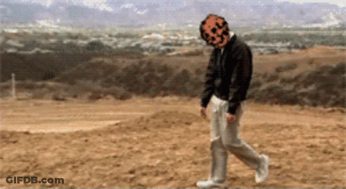A Pixelated Image Of A Man With A Pumpkin Face On His Head GIF