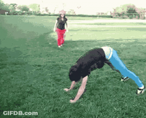 A Pixelated Image Of A Person Doing A Handstand In A Park GIF