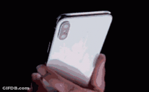 A Pixelated Image Of A Person Holding A White Iphone GIF
