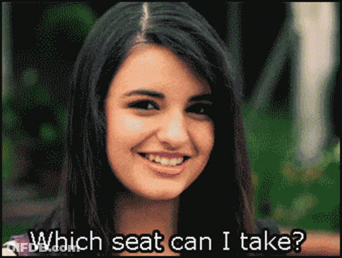 A Pixelated Image Of A Smiling Woman With The Words Which Seat Can I Take Below Her GIF