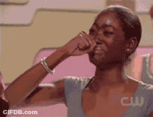 A Pixelated Image Of A Woman Covering Her Nose With Her Hand With A Cw Logo Behind Her GIF
