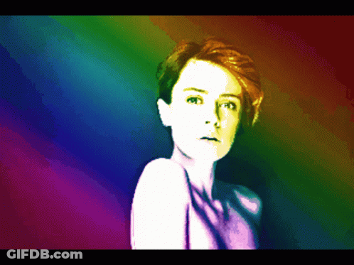 A Pixelated Image Of A Woman With A Rainbow Colored Background GIF