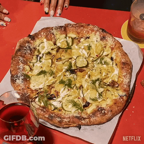 A Pizza With A Glass Of Wine Next To It And A Netflix Logo GIF