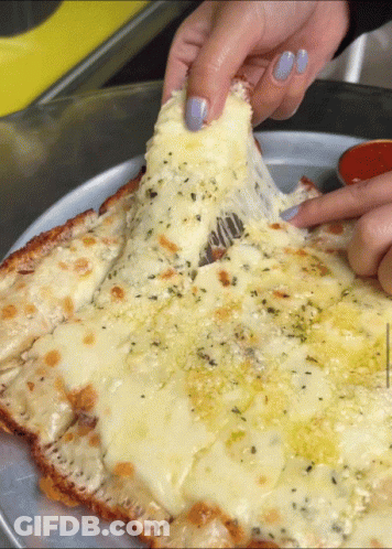 A Pizza With A Lot Of Cheese On It GIF