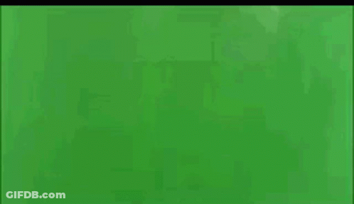 A Plane Is Exploding On A Green Screen With Smoke Coming Out Of It GIF