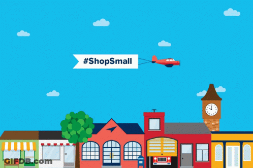 A Plane Is Flying Over A Small Town With A Banner That Says #Shopssmall GIF