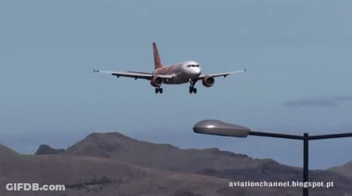A Plane Is Flying Over A Street Light With The Words Aviationchannel.blogspot.pt Written Below It GIF