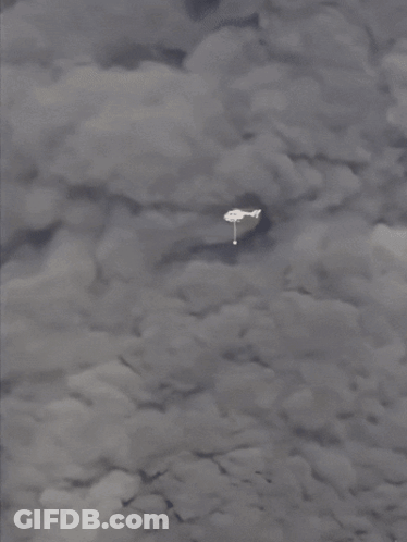 A Plane Is Flying Through A Cloudy Sky With A White Object In The Foreground GIF