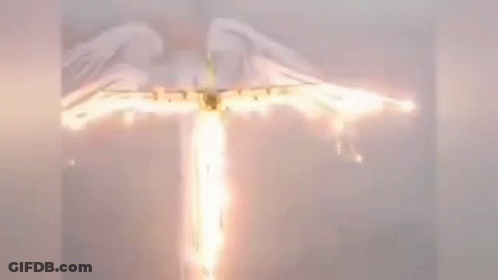 A Plane Is Flying Through The Air With A Flame Coming Out Of It . GIF