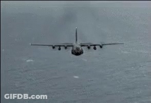 A Plane Is Flying Through The Air With Fire Coming Out Of The Wings GIF