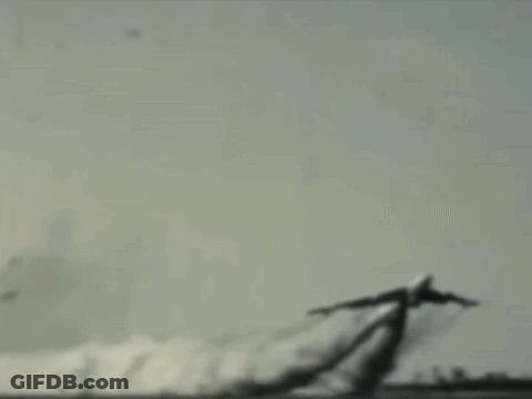 A Plane Is Flying Through The Air With Smoke Trails Behind It GIF