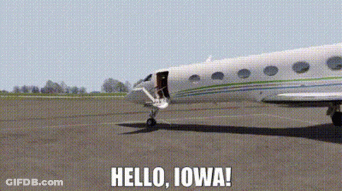 A Plane Is Sitting On A Runway With The Words Hello Iowa Written Below It GIF