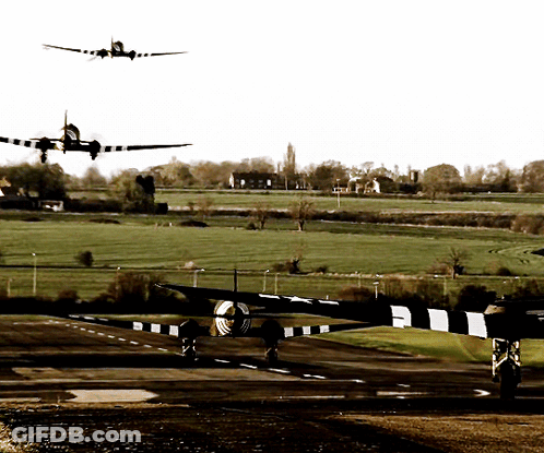 A Plane Is Taking Off From A Runway And Another Plane Is Flying In The Background GIF