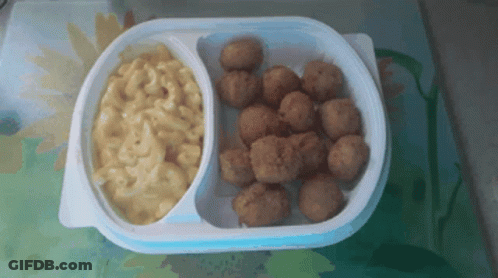 A Plastic Container Of Macaroni And Cheese And Fried Chicken Balls GIF