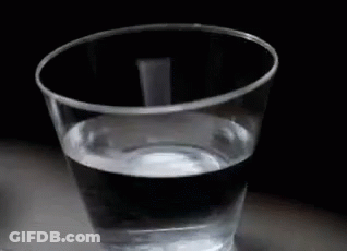 A Plastic Cup Filled With Water On A Table . GIF