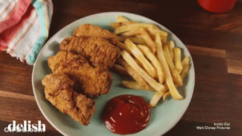 A Plate Of Chicken Nuggets And French Fries With Ketchup On It GIF