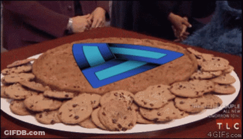 A Plate Of Chocolate Chip Cookies With A Blue Triangle In The Middle GIF