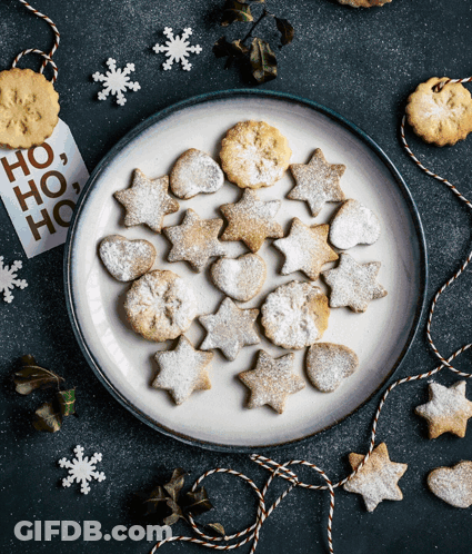 A Plate Of Cookies With A Tag That Says Ho Ho Ho On It GIF