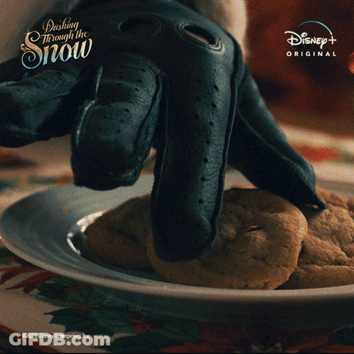 A Plate Of Cookies With The Words Dashing Through The Snow On The Top GIF