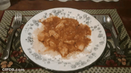 A Plate Of Food On A Placemat With A Fork And Spoon GIF