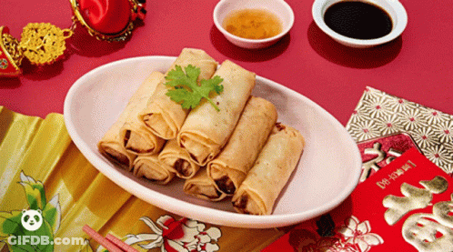 A Plate Of Food With Chopsticks And A Red Envelope That Says ' Fortune ' On It GIF