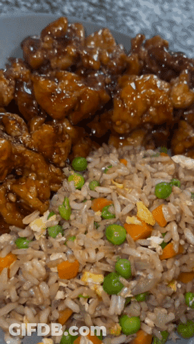 A Plate Of Food With Rice And Peas On It GIF