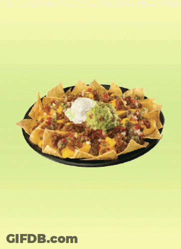 A Plate Of Nachos With Guacamole And Sour Cream On A Green Background GIF