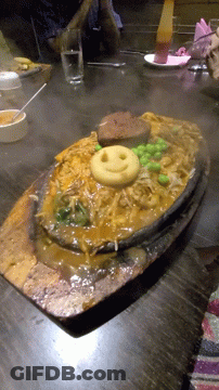 A Plate Of Noodles With A Smiley Face On Top GIF