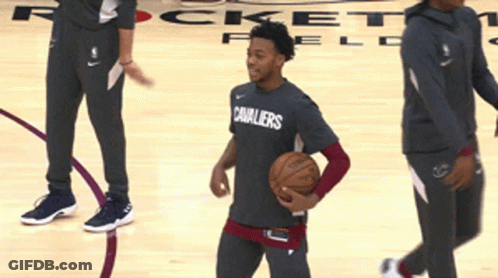 A Player For The Cavaliers Dribbles A Basketball On A Court GIF