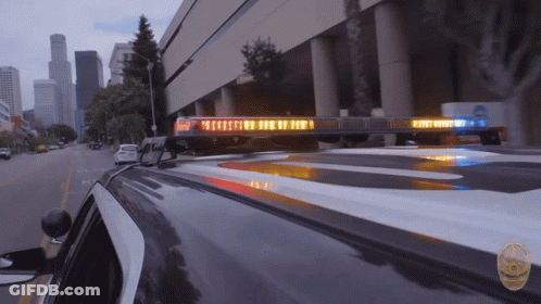 A Police Car With A Light On The Roof That Says Emergency GIF