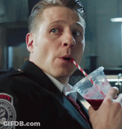 A Police Officer Drinks Through A Straw From A Cup With A Badge On His Shoulder GIF