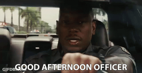 A Police Officer Is Driving A Car With The Words `` Good Afternoon Officer '' Written On The Screen . GIF